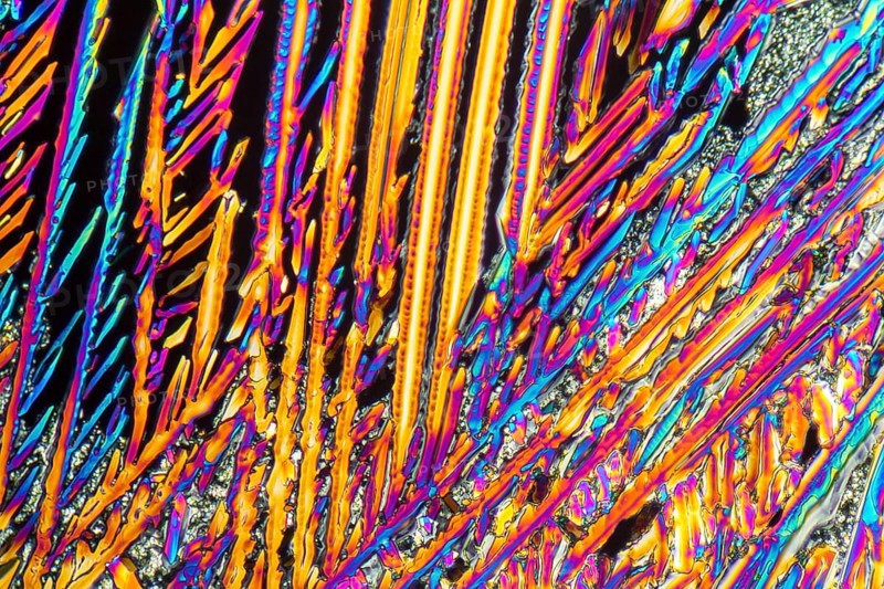 Colorful microscopic shot of Sodium nitrate microcrystals in polarized light