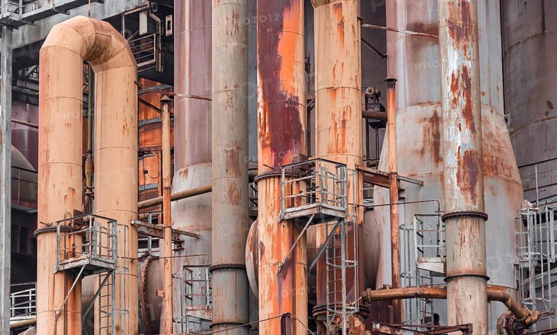 Weathered rusty industrial scenery with old corroded steel girders and metal tubes