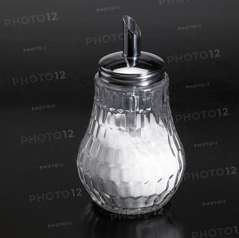 Studio photography of a sugar sprinkler made of glass and metal in dark reflective back