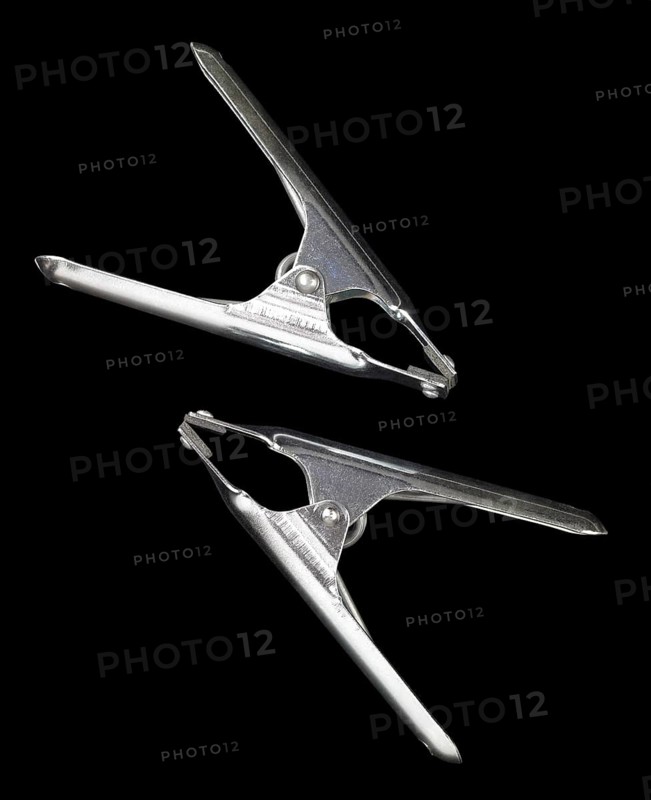Studio photography of two metal clamps isolated on black