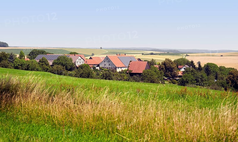 Small rural village in Southern Germany at summer time in agricultural ambiance