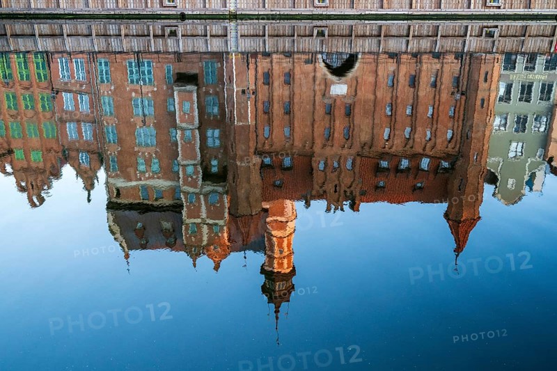 Waterfront promenade with reflection at sunrise in the Old Town, Motlawa River, Gdansk, Gdansk, Poland