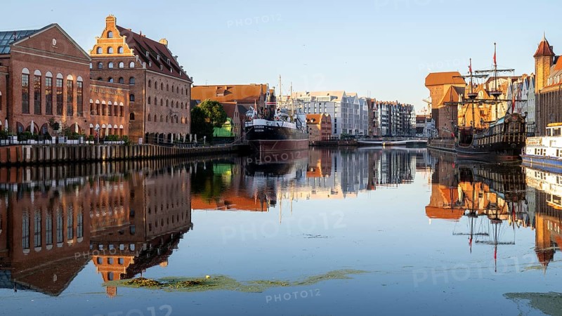 Waterfront promenade with reflection at sunrise in the Old Town, Motlawa River, Gdansk, Gdansk, Poland