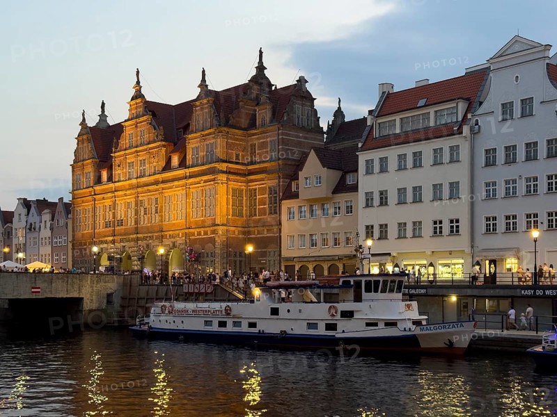 Illuminated riverside promenade at sunset in the Old Town, excursion boat, Motlawa River, Gdansk, Poland