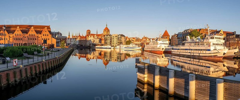 Waterfront promenade with reflection at sunrise in the Old Town, Motlawa River, Gdansk, Gdansk, Poland