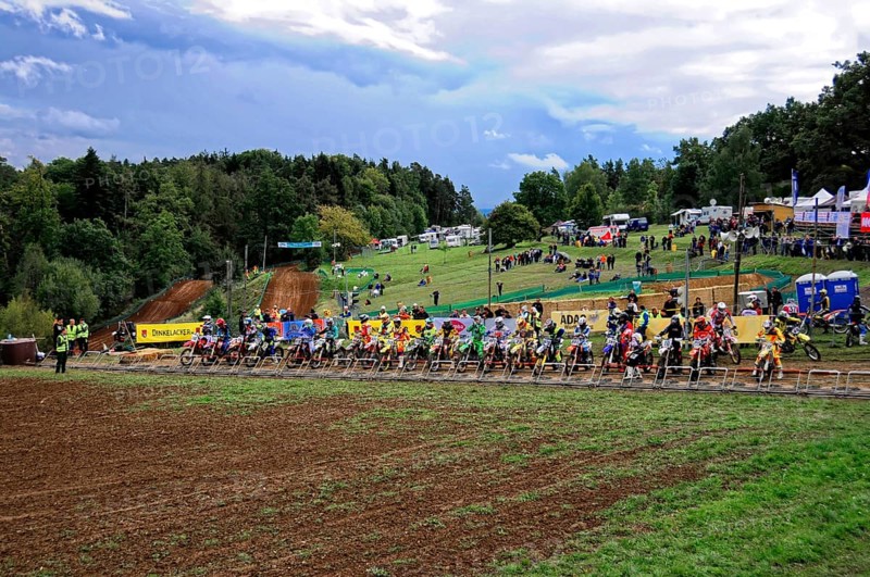 Motocross, Rudersberg, Baden-Württemberg, Germany, Europe, A large group of motocross riders wait for the start of a race on a muddy track, Rudersberg Motocross