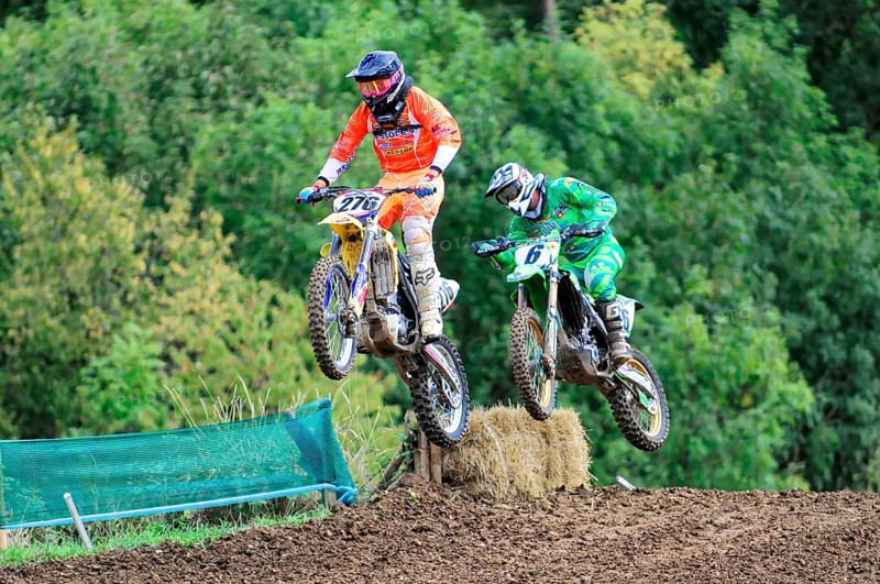 Motocross, Rudersberg, Baden-Württemberg, Germany, Europe, Two motocross riders jump over a ramp in a wooded area, Rudersberg motocross