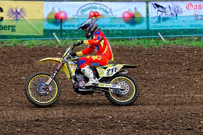 Motocross, Rudersberg, Baden-Württemberg, Germany, Europe, A rider on a yellow motorbike concentrates on the ride over a muddy track, Rudersberg Motocross