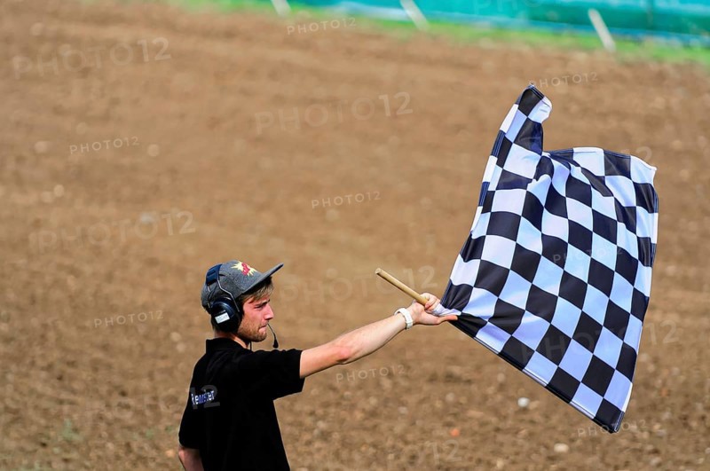 Motocross, Rudersberg, Baden-Württemberg, Germany, Europe, Man waving a black and white chequered flag on a dry field, Rudersberg motocross