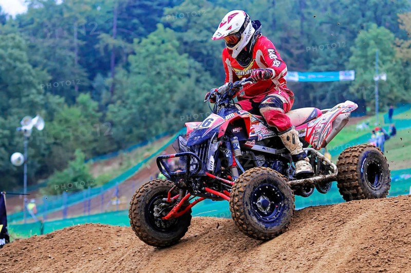 Motocross, Rudersberg, Baden-Württemberg, Germany, Europe, Rider in red protective clothing jumps over a hill on a quad bike during an off-road race, Rudersberg motocross