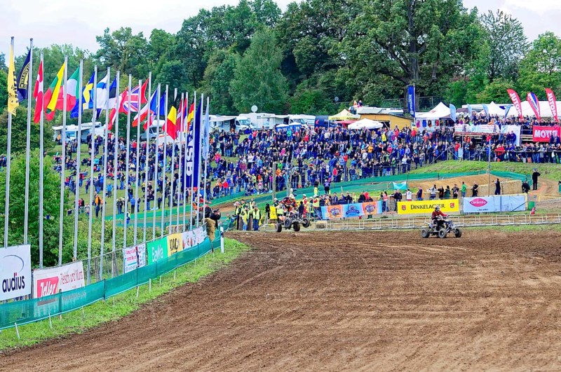 Motocross, Rudersberg, Baden-Württemberg, Germany, Europe, A race track with numerous spectators and international flags, surrounded by green trees, Rudersberg Motocross