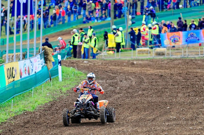 Motocross, Rudersberg, Baden-Württemberg, Germany, Europe, A quad bike pilot navigates through a muddy track while spectators watch in the background, Rudersberg Motocross