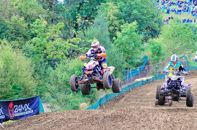 Motocross, Rudersberg, Baden-Württemberg, Germany, Europe, A quad bike rider jumps over a track surrounded by forest and spectators during a race, Rudersberg Motocross