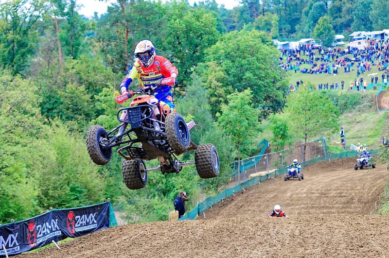 Motocross, Rudersberg, Baden-Württemberg, Germany, Europe, A quadbike drives in the air over a track while spectators watch the spectacle, Rudersberg Motocross
