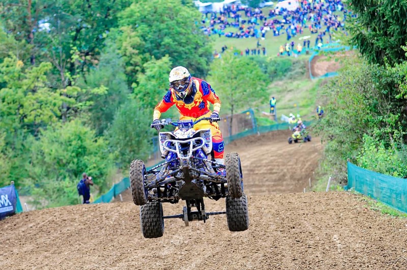 Motocross, Rudersberg, Baden-Württemberg, Germany, Europe, A quad bike rider jumps over a track, followed by spectators in the background, Rudersberg Motocross