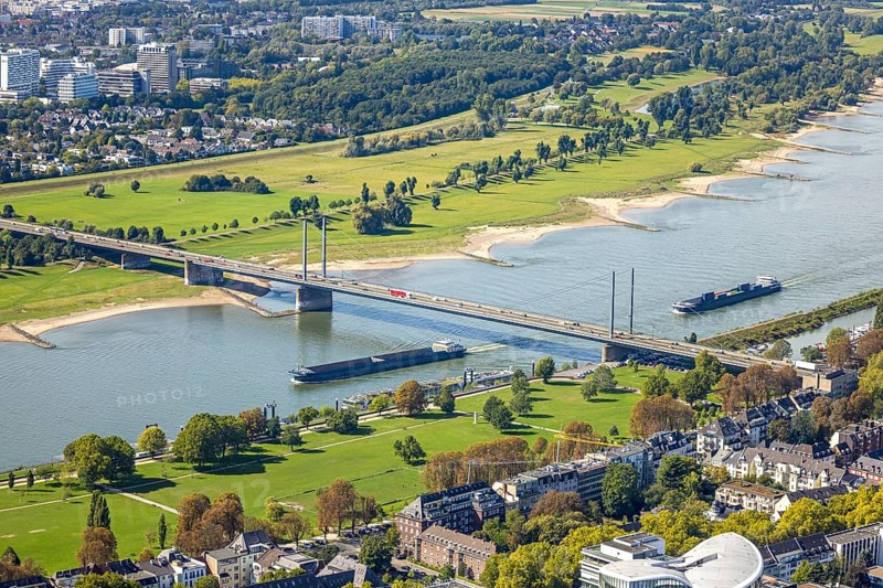 Aerial view, Theodor-Heuss-Bridge and inland navigation on the river Rhine, in front Rheinpark Golzheim, behind Niederkasseler Deich, Niederkassel, Düsseldorf, Ruhr area, North Rhine-Westphalia, Germany, inland navigation, bridge, DE, Europe, river, aerial view, aerial photography, aerial photography, road traffic, overview, bird's-eye view, overview
