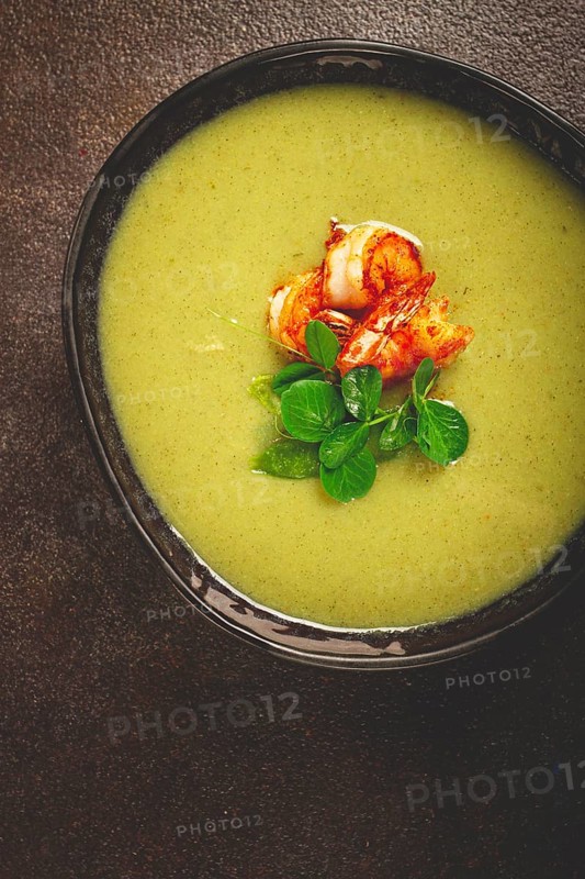 Pea cream soup, with shrimp, green soup, homemade, top view, no people