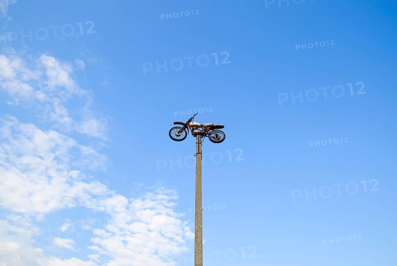 Motorcycle on the pedestal. A light motorbike on a pole, put up as a dummy or a monument. Krasnodar, Russia
