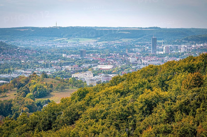 View of Jena city centre with the Jentower skyscraper, surrounded by forests and mountains, Jena, Thuringia, Germany