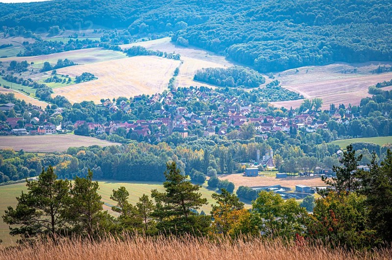 Small village of Kunitz in a hilly landscape with fields and forests, Jena, Thuringia, Germany