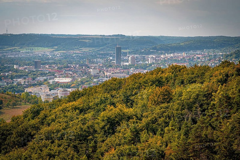 Jena city centre with a striking high-rise building Jentower, surrounded by forests under a grey sky, Jena, Thuringia, Germany