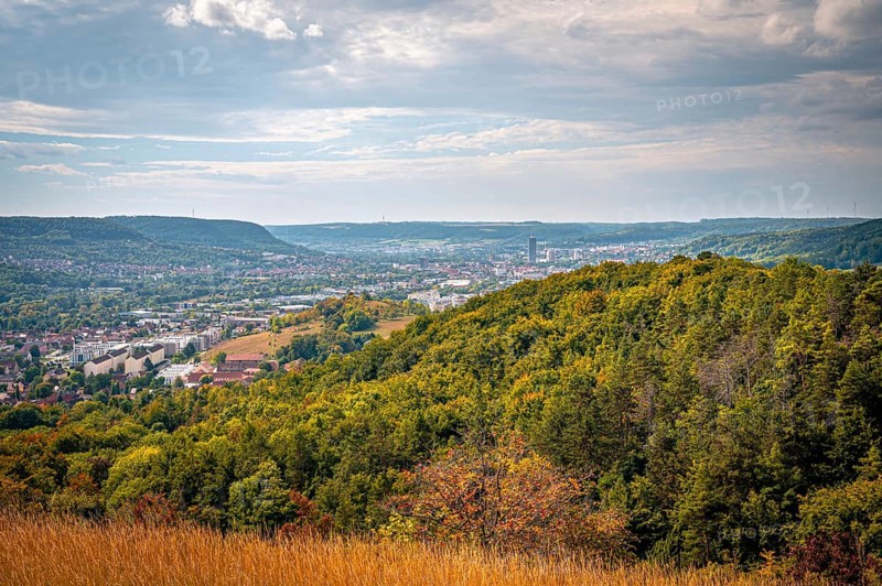 View over wooded hills to the city centre of Jena, partly cloudy sky, Jena, Thuringia, Germany