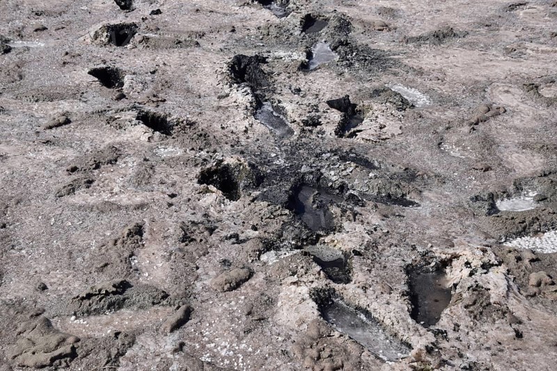 Traces of human feet in the salt lake of mud. Taman, Krasnodar Krai, Russia