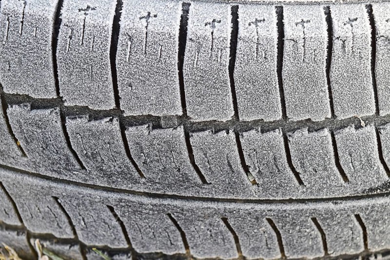 Hoarfrost on a rubber tire wheel. Morning frost