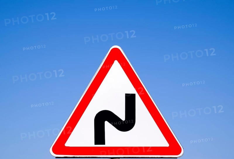 Road sign dangerous turn. Warning a sign. Krasnodar, Russia