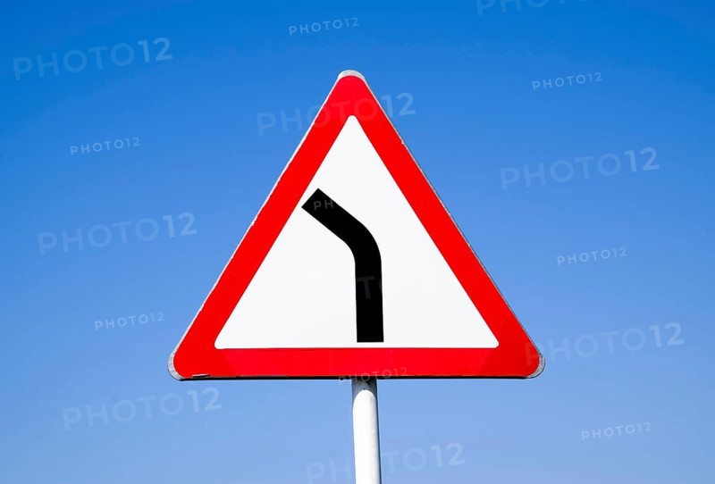 Road sign dangerous turn. Warning a sign. Krasnodar, Russia
