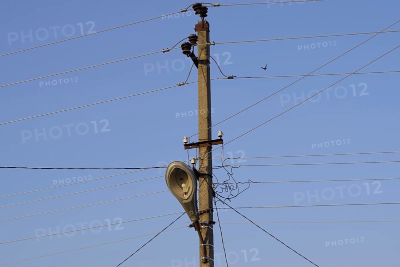 Power line post with a street lighting lamp. Krasnodar, Russia