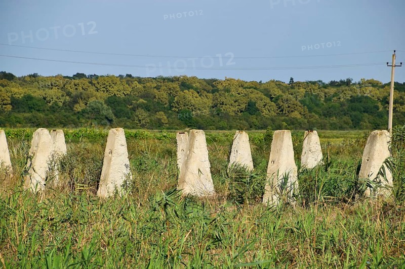 The ruins of the old farm. Cones column base of the wall. Abandoned and ruined buildings