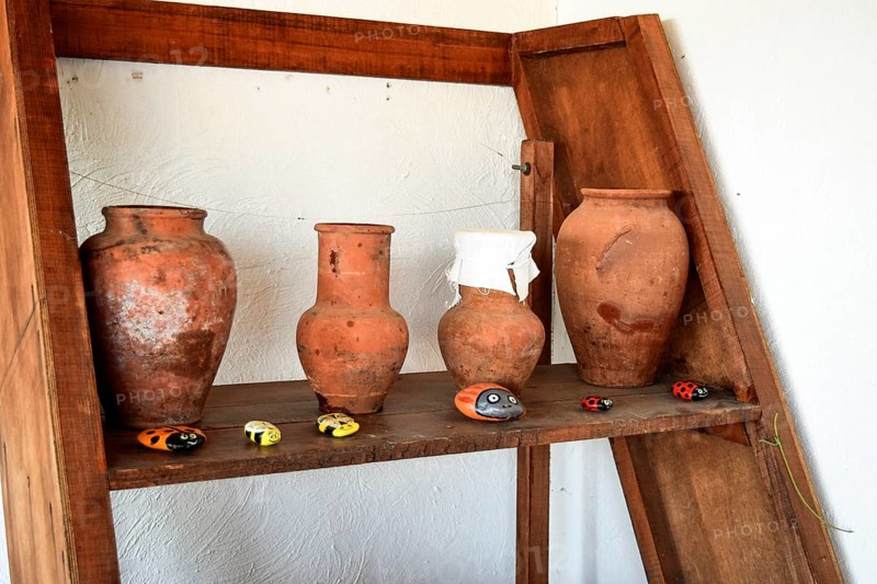 Shelves with standing on their utensils of porcelain and earthenware. Taman, Krasnodar Krai, Russia