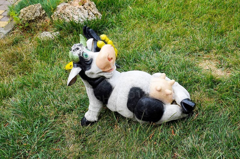 Toy cow lying upside udder. Taman, Krasnodar Krai, Russia