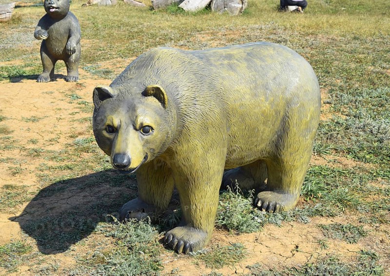 Mannequin dummy bear on the lawn. Taman, Krasnodar Krai, Russia
