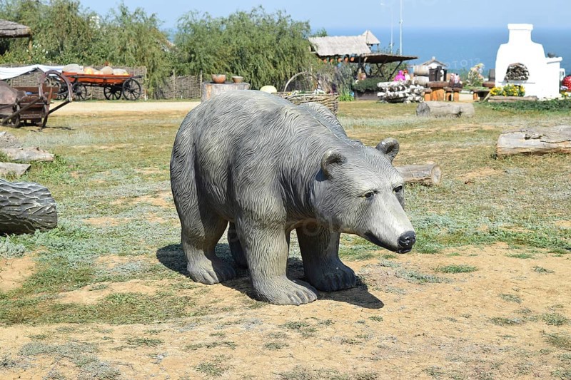Mannequin dummy bear on the lawn. Taman, Krasnodar Krai, Russia