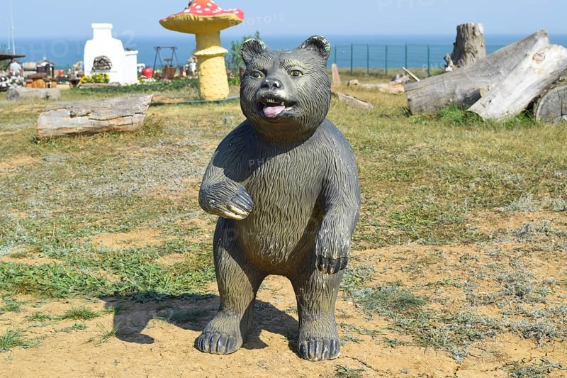 Mannequin dummy bear on the lawn. Taman, Krasnodar Krai, Russia
