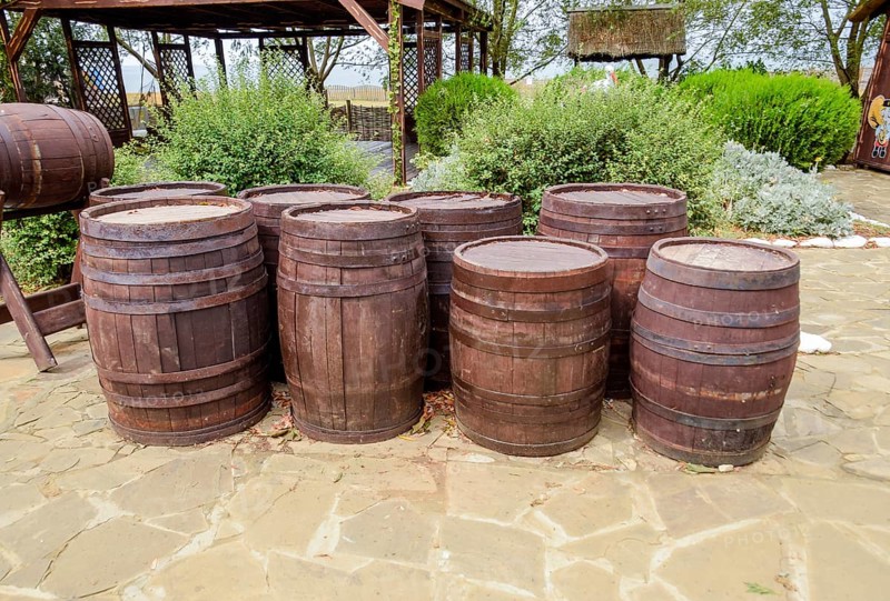 Stacked wine barrels. Decoration of the barrels in the village Ataman. Taman, Krasnodar Krai, Russia