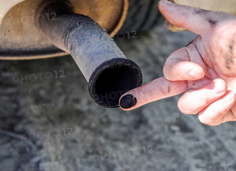 Soot from the exhaust pipe on the finger. Atyrau, Kazakhstan