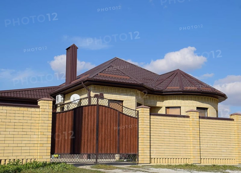 Decorative metal on the roof of a brick house. Atyrau, Kazakhstan