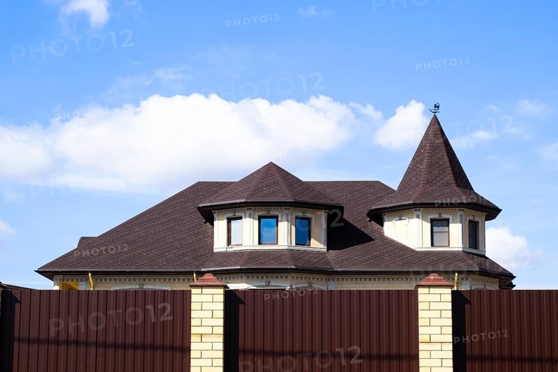 Decorative metal on the roof of a brick house. Atyrau, Kazakhstan