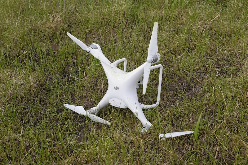 The crashed drone. Dirty and in the juice of the grass is a quadrocopter. Atyrau, Kazakhstan