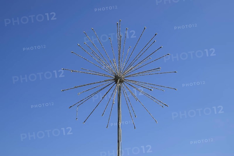 Street lamp in the form of fireworks. Garlands on a steel frame in the shape of a ball fireworks. Atyrau, Kazakhstan