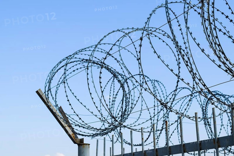 Barbed wire on the fence. Atyrau, Kazakhstan