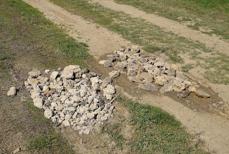 Road patching. Pits on the road are covered with stones. Atyrau, Kazakhstan