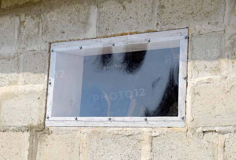 A window made of plexiglas in a concrete wall. Atyrau, Kazakhstan