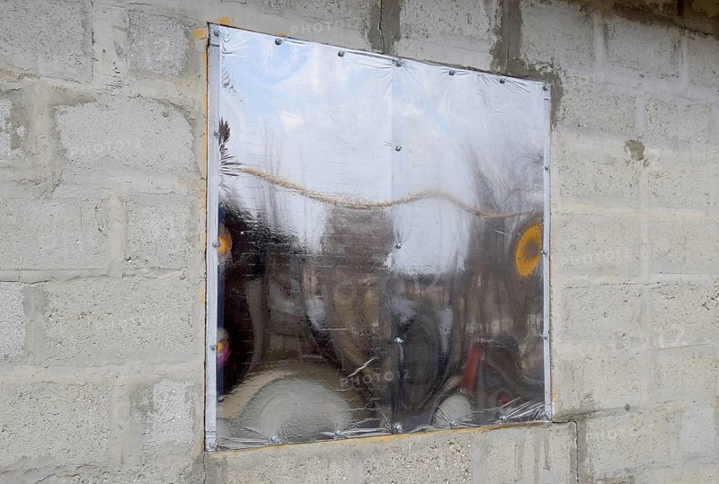 A window made of plexiglas in a concrete wall. Atyrau, Kazakhstan