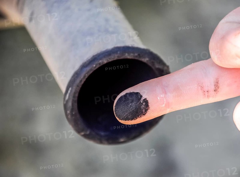 Soot from the exhaust pipe on the finger. Atyrau, Kazakhstan