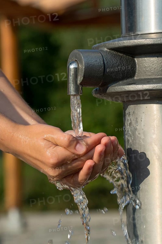 Catching Fresh And Cool Water And Cleaning Hands In An Artificial Spring, Austria