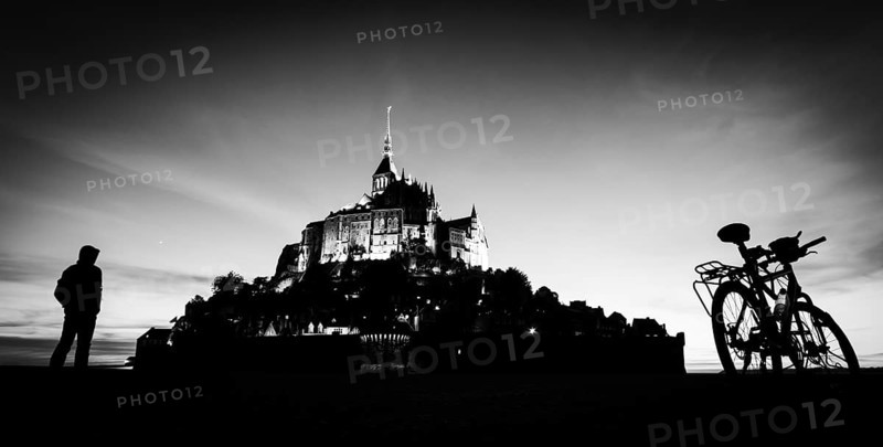 Saint Michel mount in France silhouette with person and bicycle
